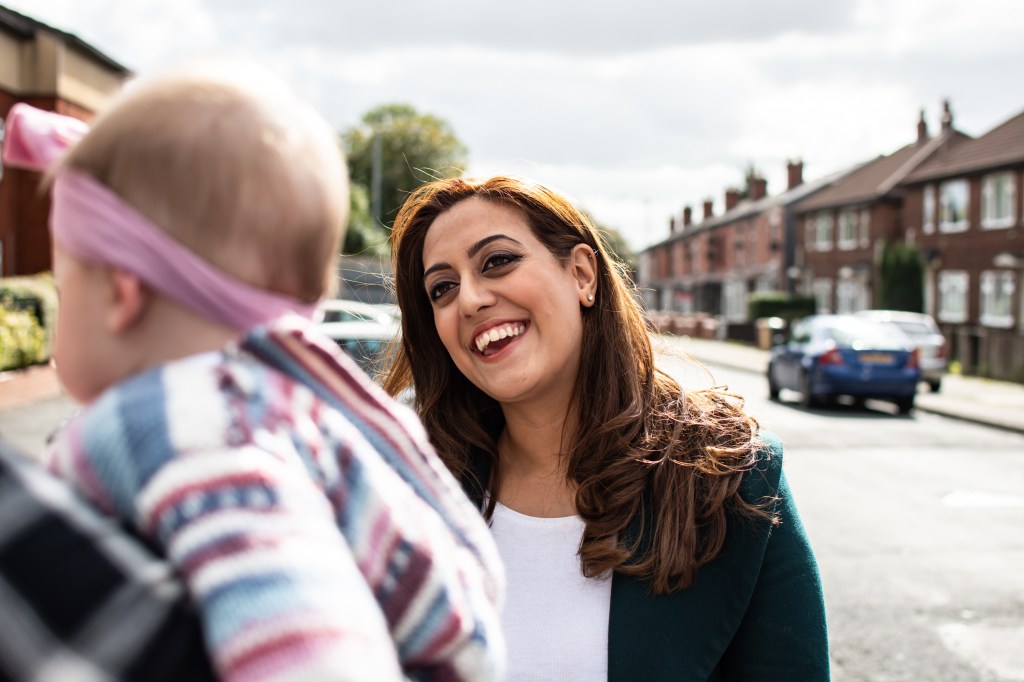 Kirith Entwistle MP interacting with a mother and baby